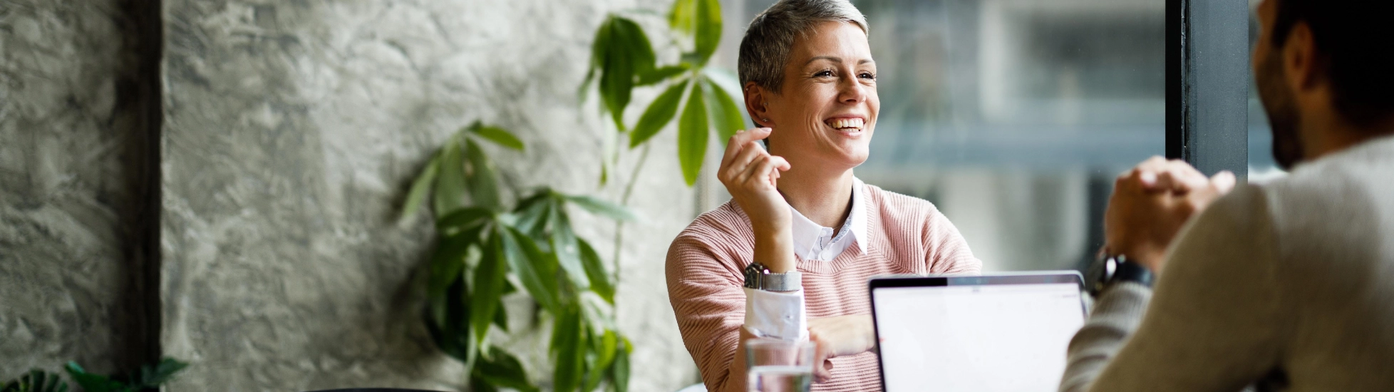 woman and man talking behind laptop right 