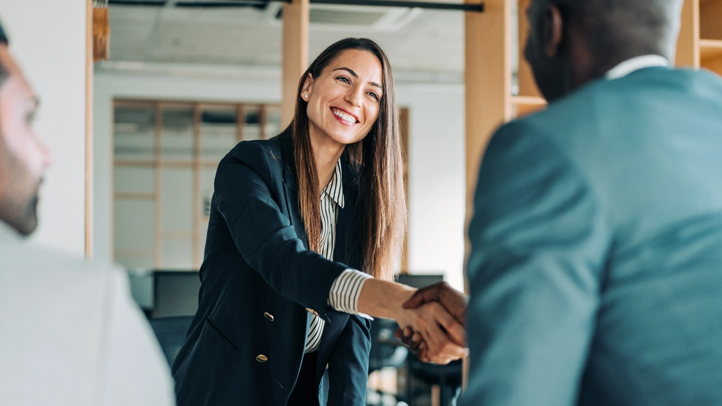 woman shakes hand of man woman shakes hand of man